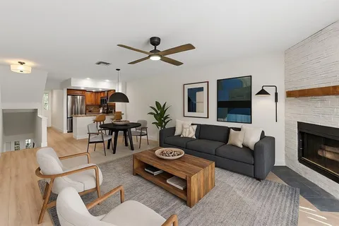 a kitchen with stainless steel appliances granite countertop a sink stove microwave and cabinets