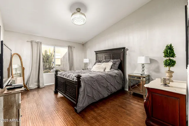 a bedroom with a bed and a chandelier