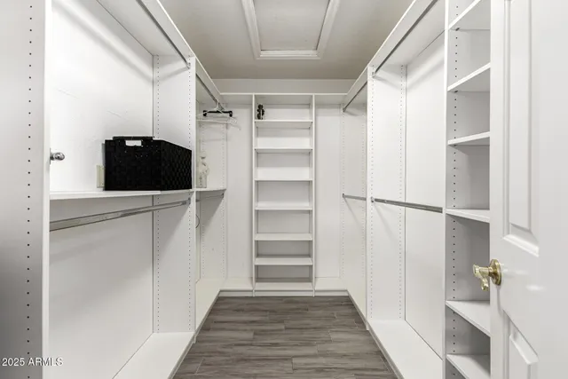 a spacious bedroom with a bed and a chandelier