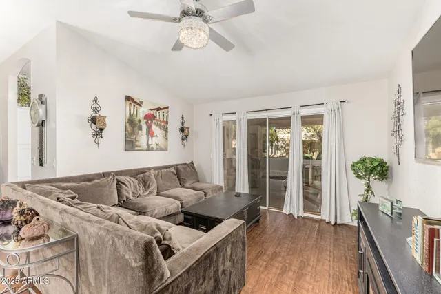 a living room with furniture and wooden floor