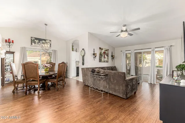 a living room with furniture dining table and wooden floor