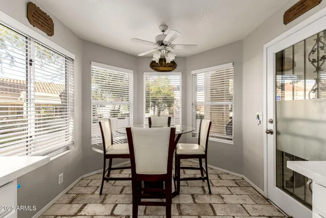 a dining room with furniture a chandelier and window