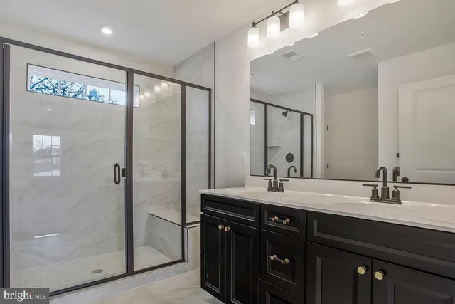 a bathroom with a double vanity sink and mirror