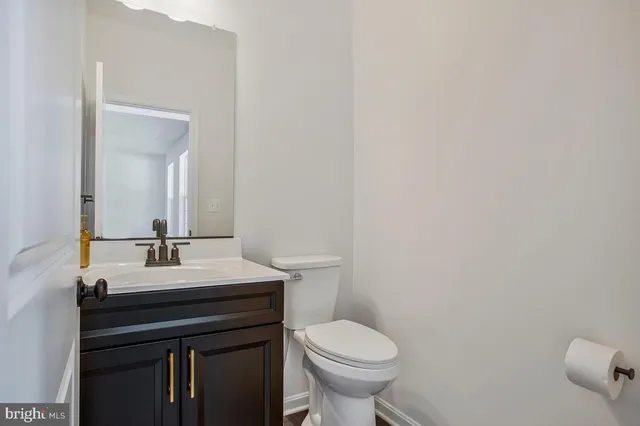 a bathroom with a sink a toilet and mirror