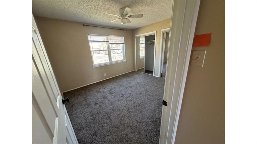 4004 Vicky Street Big Spring, TX 79720 - Photo 20 of 37 Unfurnished bedroom with carpet flooring, a ceiling fan, a closet, and a textured ceiling