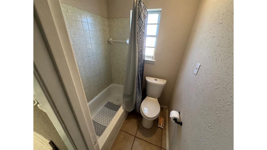 4004 Vicky Street Big Spring, TX 79720 - Photo 21 of 37 Full bathroom with a stall shower and light tile patterned flooring
