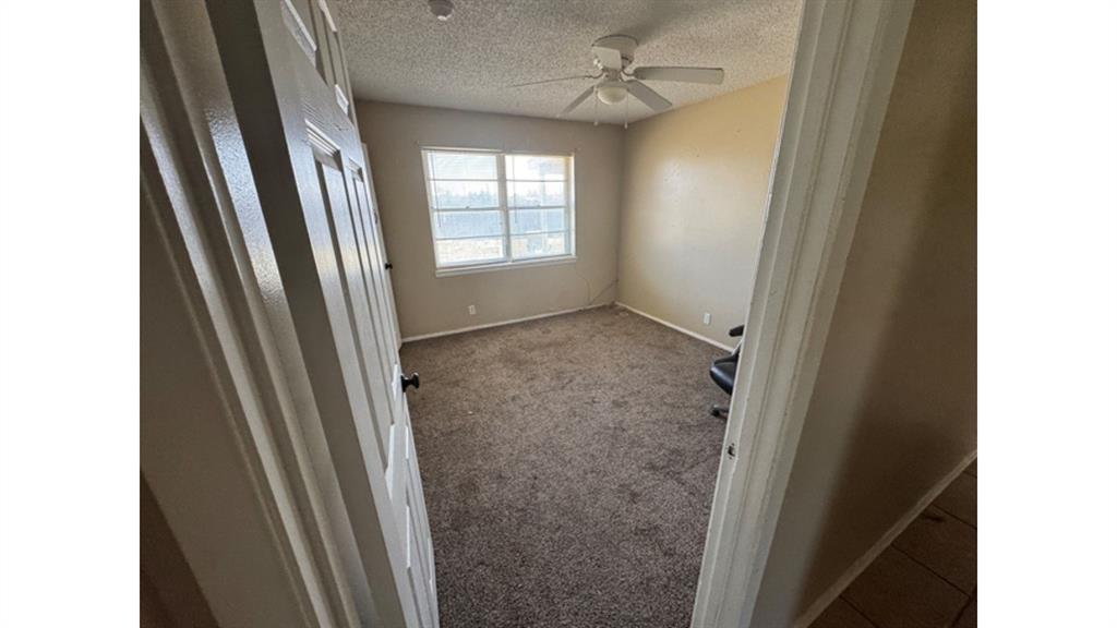 4004 Vicky Street Big Spring, TX 79720 - Photo 26 of 37 Empty room featuring carpet flooring, a textured ceiling, and ceiling fan