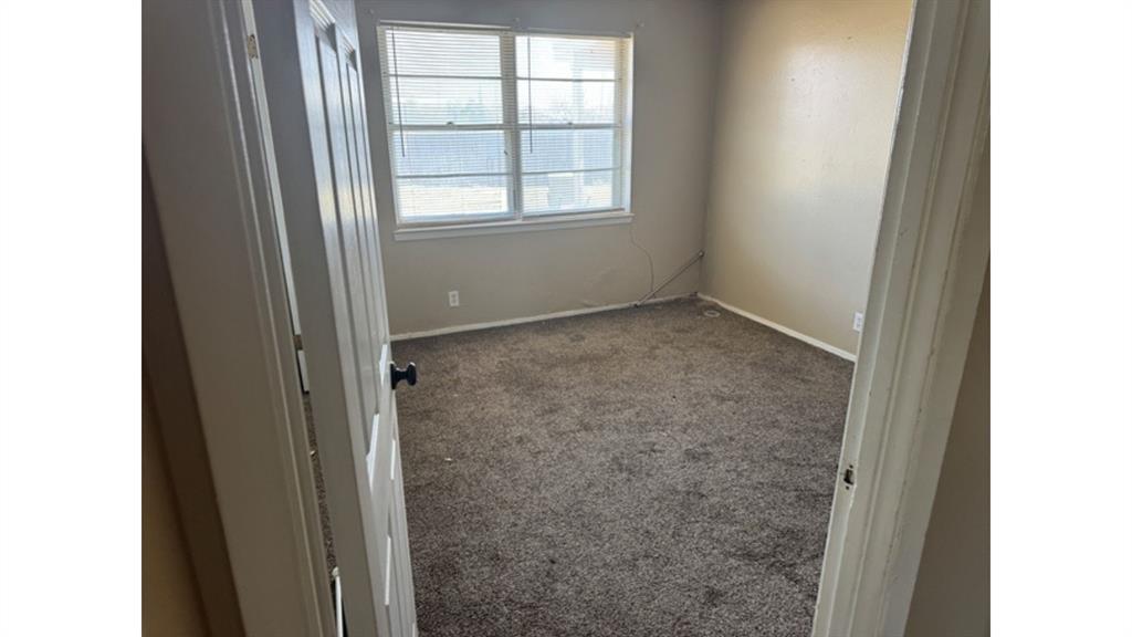 4004 Vicky Street Big Spring, TX 79720 - Photo 27 of 37 Carpeted empty room featuring baseboards
