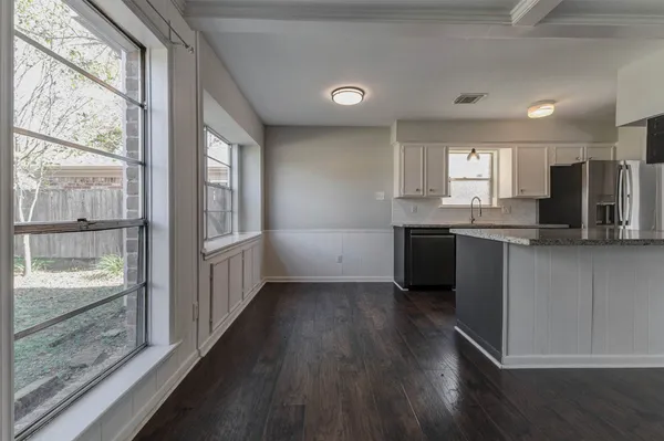 a kitchen with stainless steel appliances granite countertop a stove a sink and a refrigerator