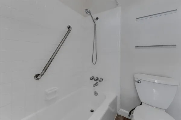 a bathroom with a toilet and a bathtub