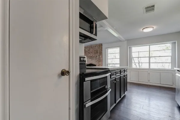 a kitchen with stainless steel appliances granite countertop a stove and a refrigerator
