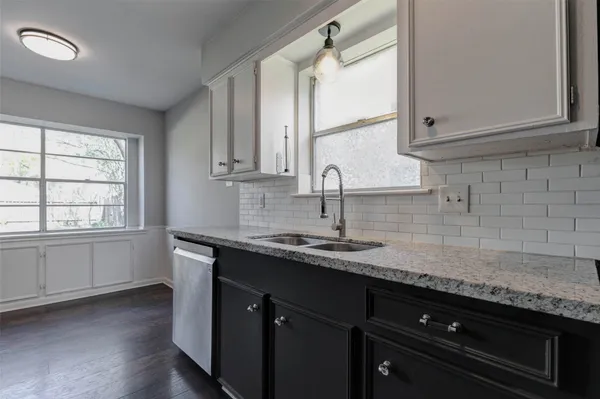 a kitchen with a sink and cabinets