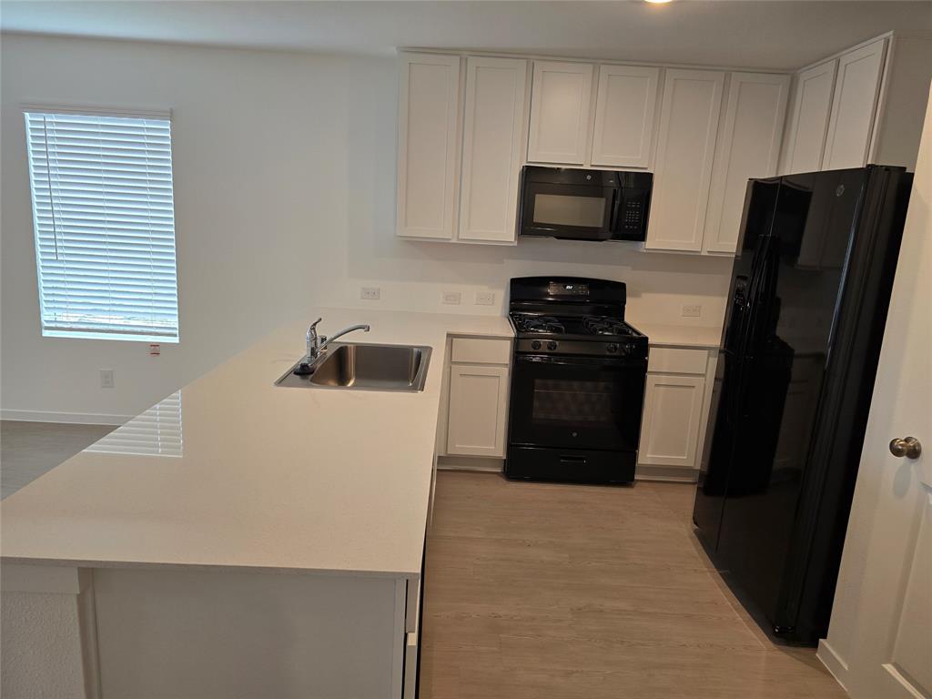 1165 Barbary Flds Street Forney, TX 75126 - Photo 12 of 24 a kitchen with a refrigerator stove and microwave