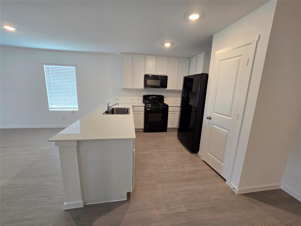 1165 Barbary Flds Street Forney, TX 75126 - Photo 10 of 24 a kitchen with stainless steel appliances a refrigerator and a stove top oven