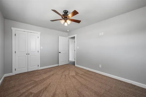 a view of empty room with ceiling fan