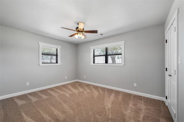 a view of room with a ceiling fan and window