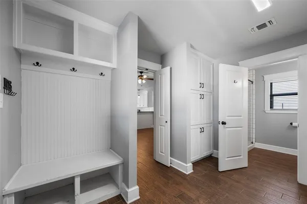 a view of empty room with wooden floor