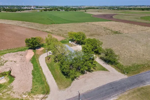 an aerial view of a house with a yard and lake view
