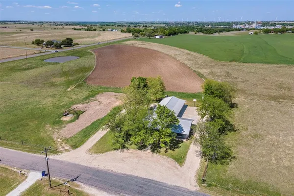 an aerial view of a house with a yard and lake view