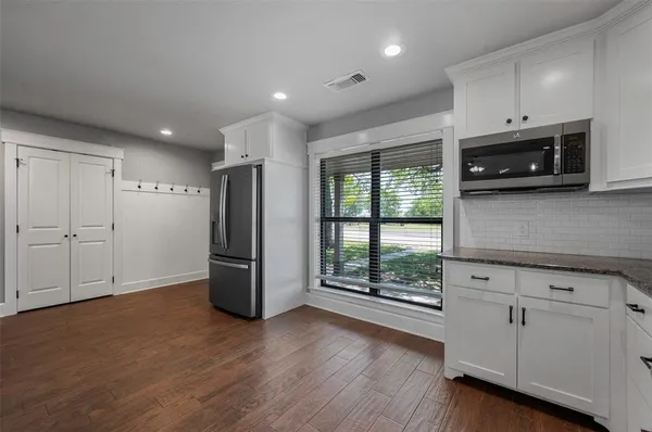 a kitchen with refrigerator and stove