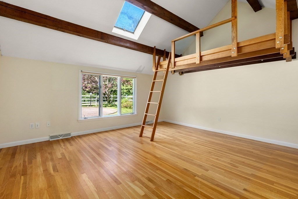 55 Westerly Road Weston, MA 02493 - Photo 19 of 30 a view of an empty room with wooden floor and a window