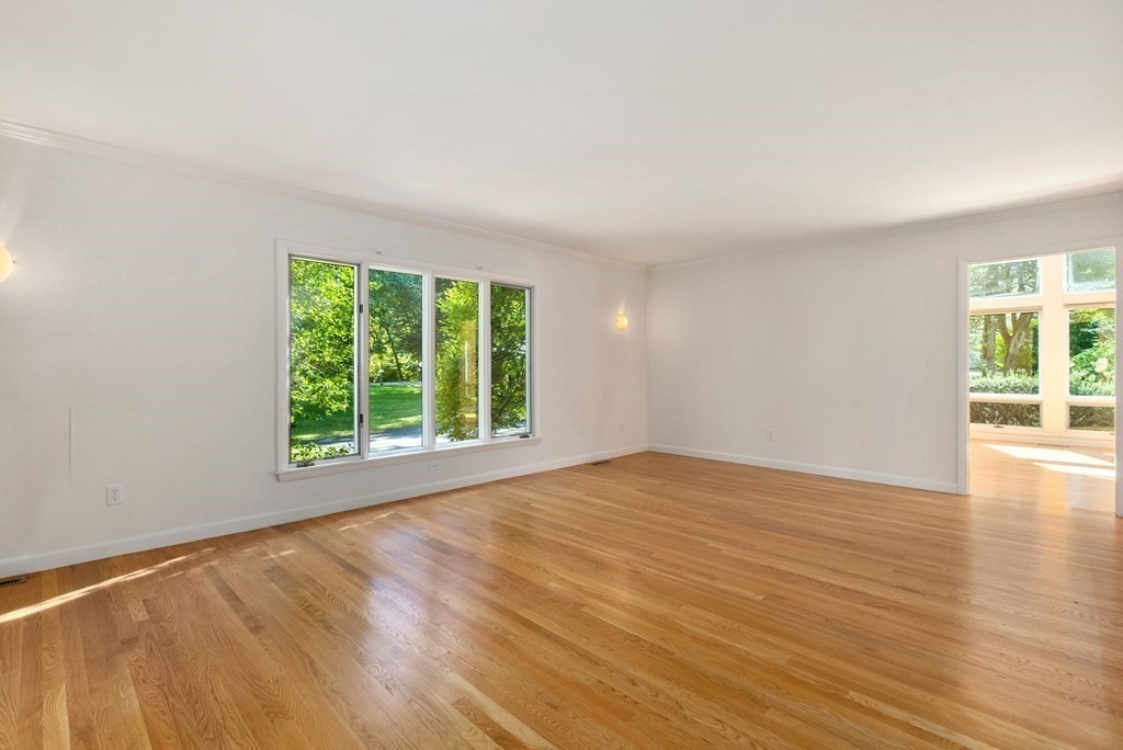 55 Westerly Road Weston, MA 02493 - Photo 20 of 30 a view of an empty room with wooden floor and a window