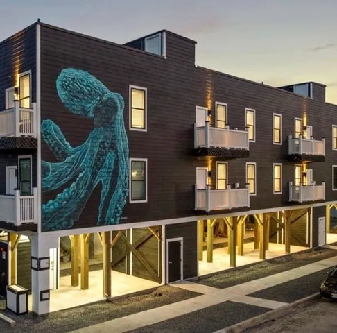 a view of a brick building next to a road