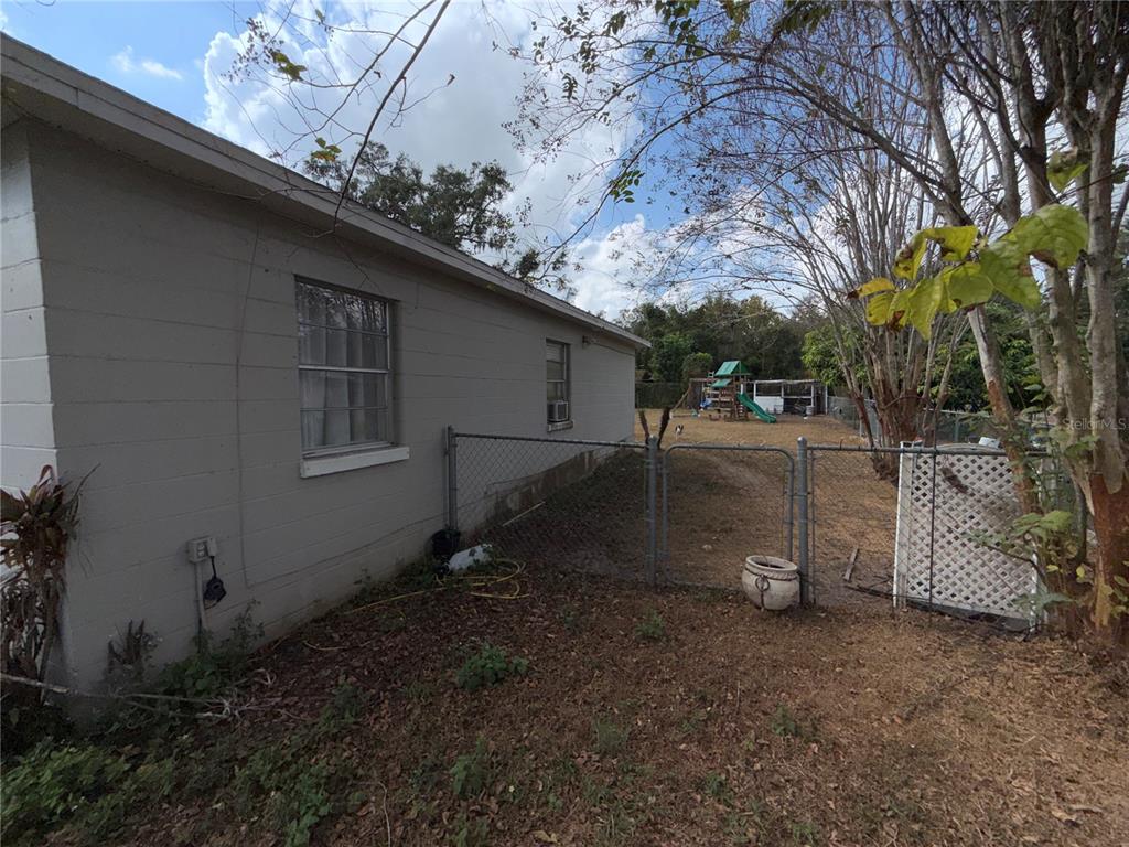 4530 Swinger Road Dover, FL 33527 - Photo 13 of 14 a backyard of a house with barbeque oven fire pit table and chairs