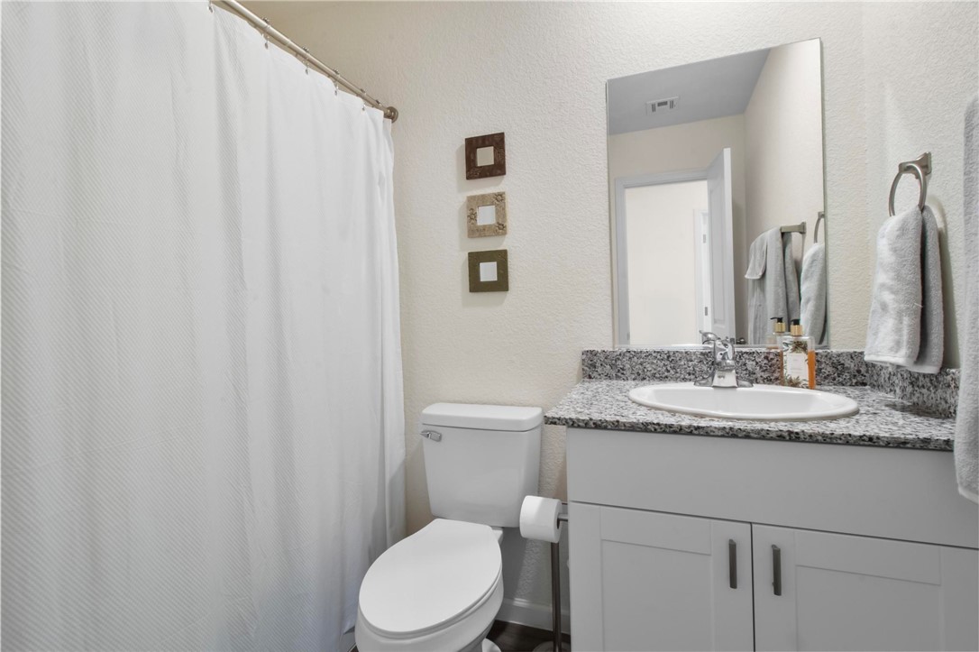 2424 Granite Road Bullhead City, AZ 86442 - Photo 18 of 50 Bathroom featuring a single vanity with stone-finish countertop, under-mount sink, and modern cabinetry