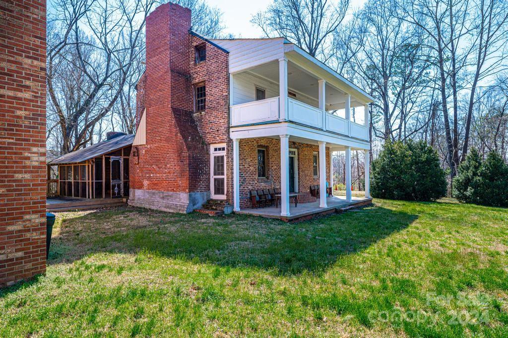 3878 Robinson Road Newton, NC 28658 - Photo 10 of 47 a view of a brick house with a big yard and large trees