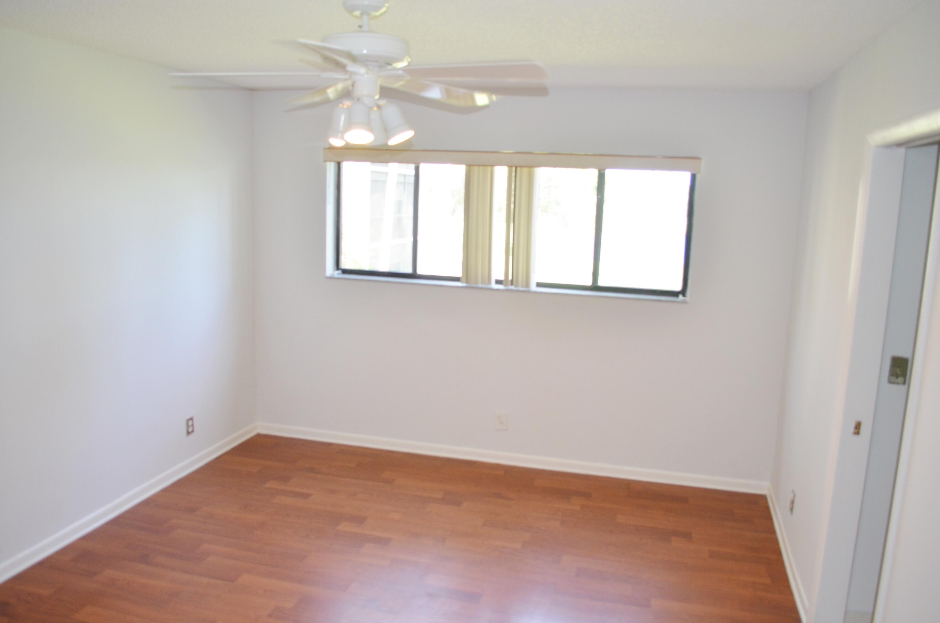 5220 Las Verdes Circle, Unit 211 Delray Beach, FL 33484 - Photo 13 of 57 an empty room with a window and a fan