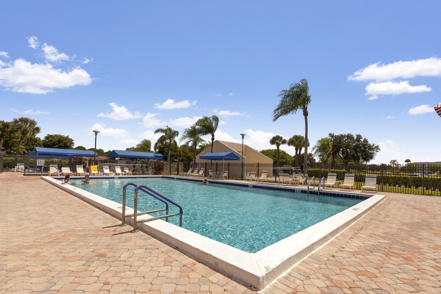 5220 Las Verdes Circle, Unit 211 Delray Beach, FL 33484 - Photo 27 of 57 a view of swimming pool with outdoor seating