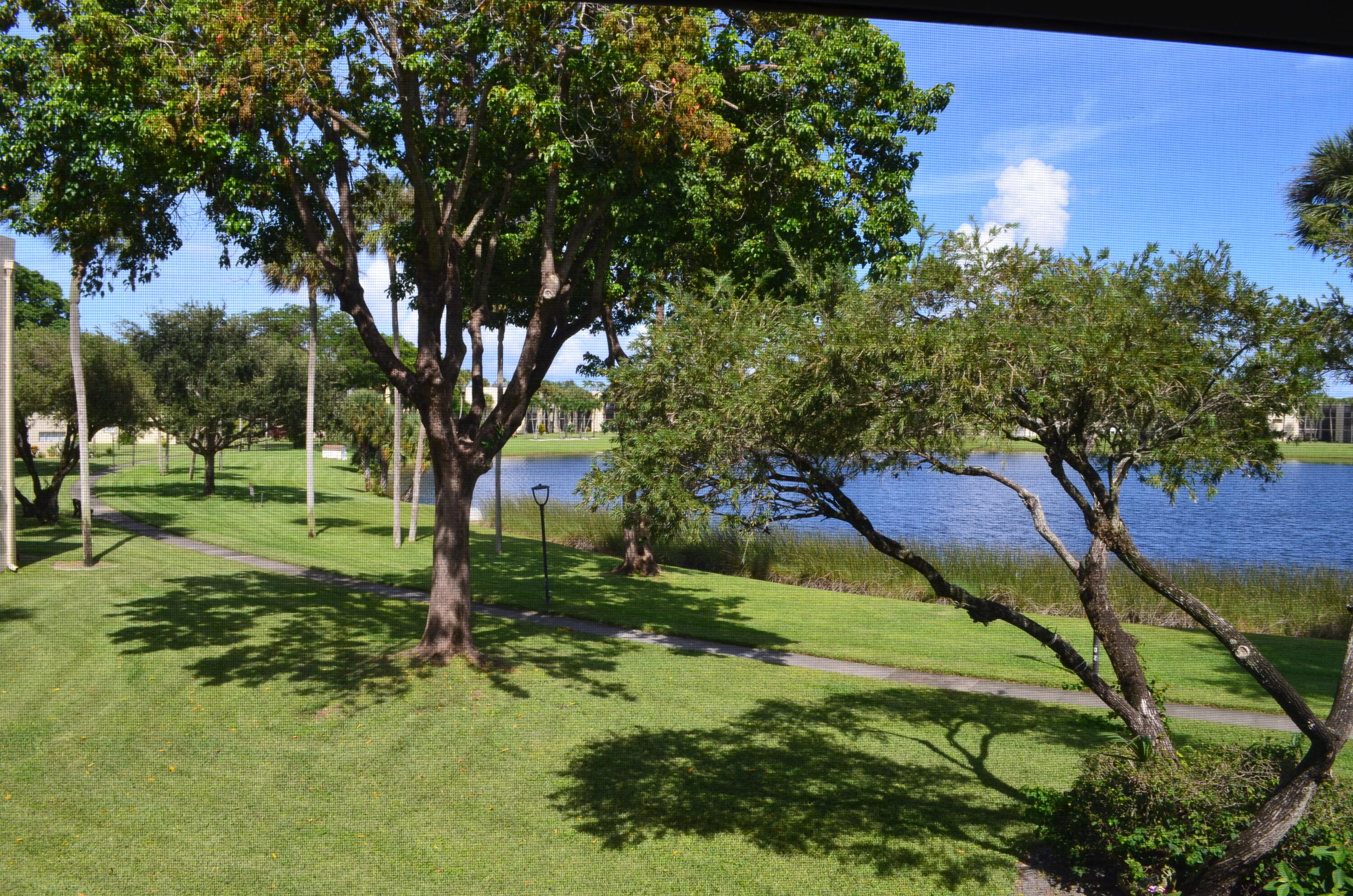 5220 Las Verdes Circle, Unit 211 Delray Beach, FL 33484 - Photo 3 of 57 a view of yard with green space