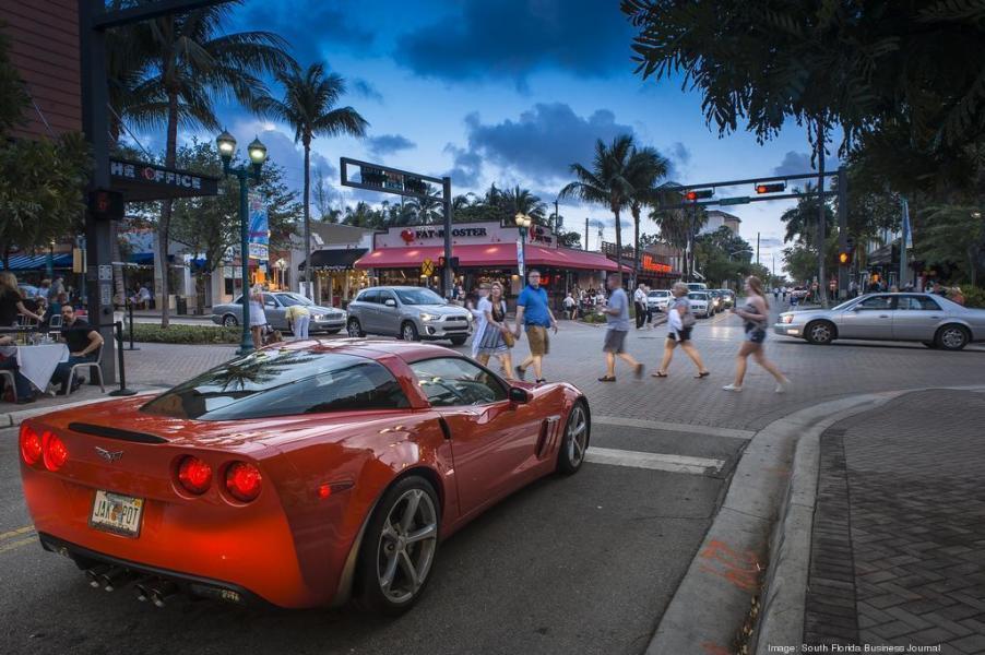 5220 Las Verdes Circle, Unit 211 Delray Beach, FL 33484 - Photo 45 of 57 a view of a cars park in front of a building