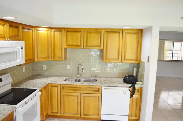 a kitchen with a sink a cabinets and window