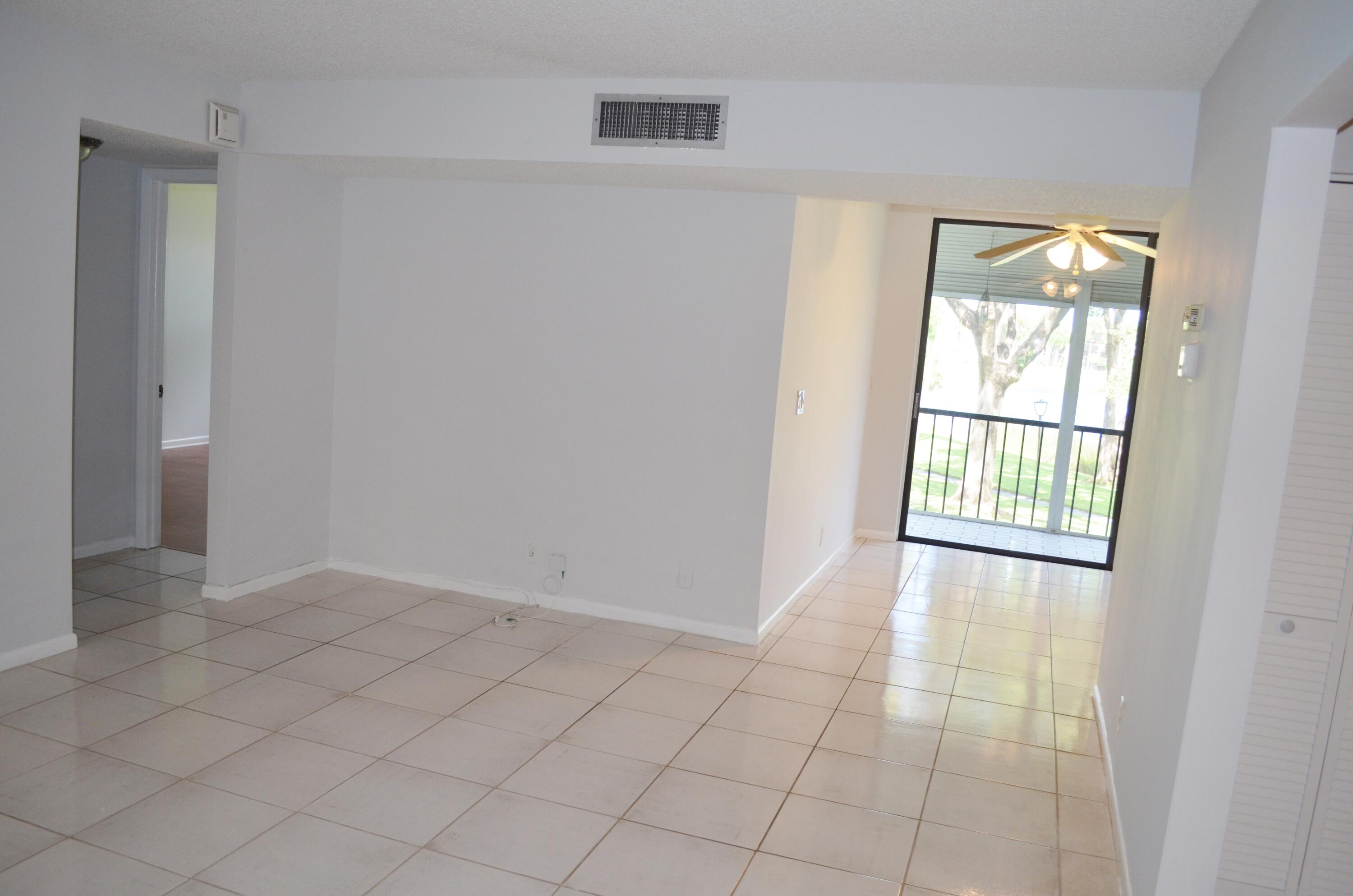 5220 Las Verdes Circle, Unit 211 Delray Beach, FL 33484 - Photo 8 of 57 a view of an empty room with a window