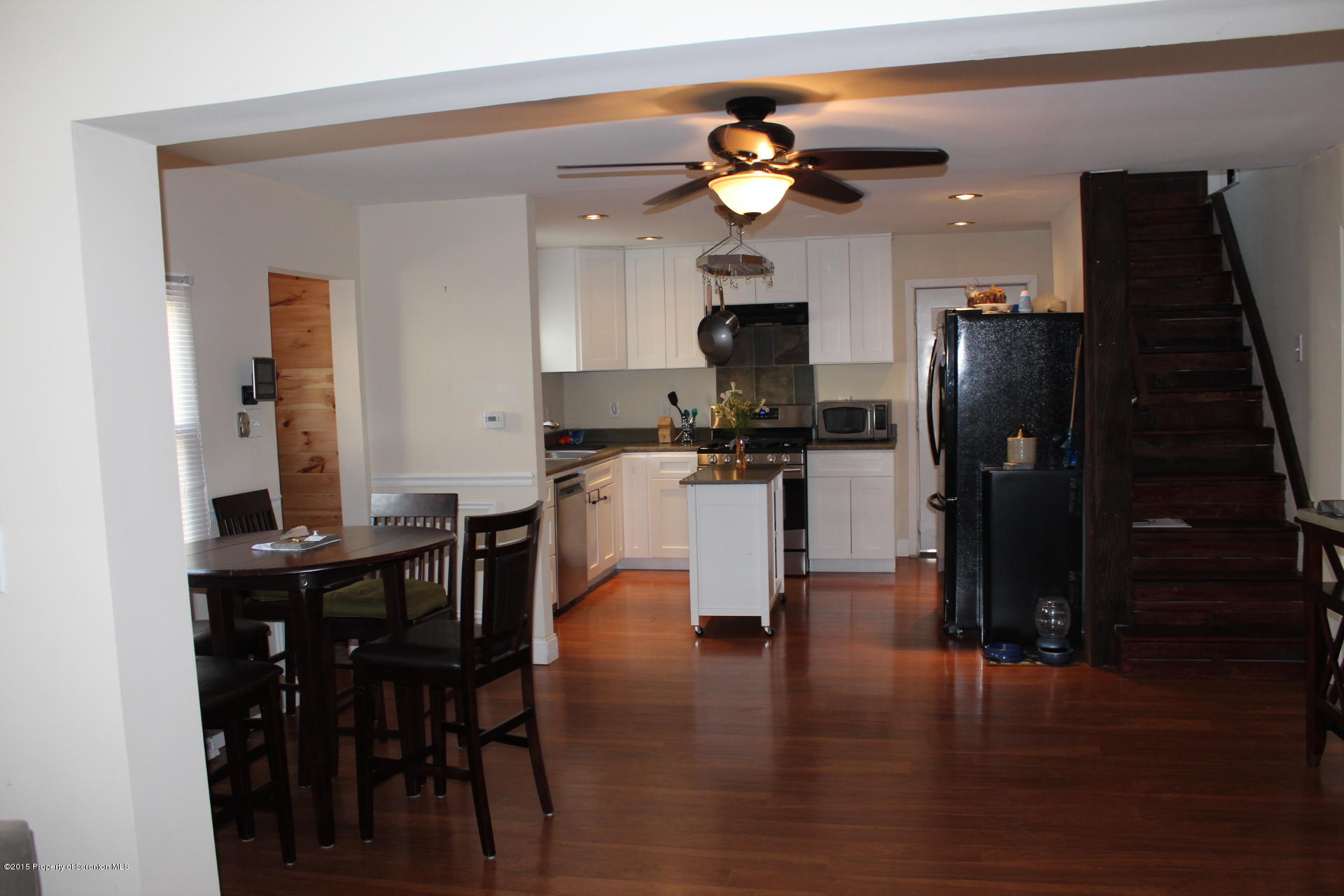 18 Linden Street Luzerne, PA 18709 - Photo 6 of 21 a kitchen with stainless steel appliances kitchen island granite countertop a refrigerator a stove a sink and dishwasher with wooden floor