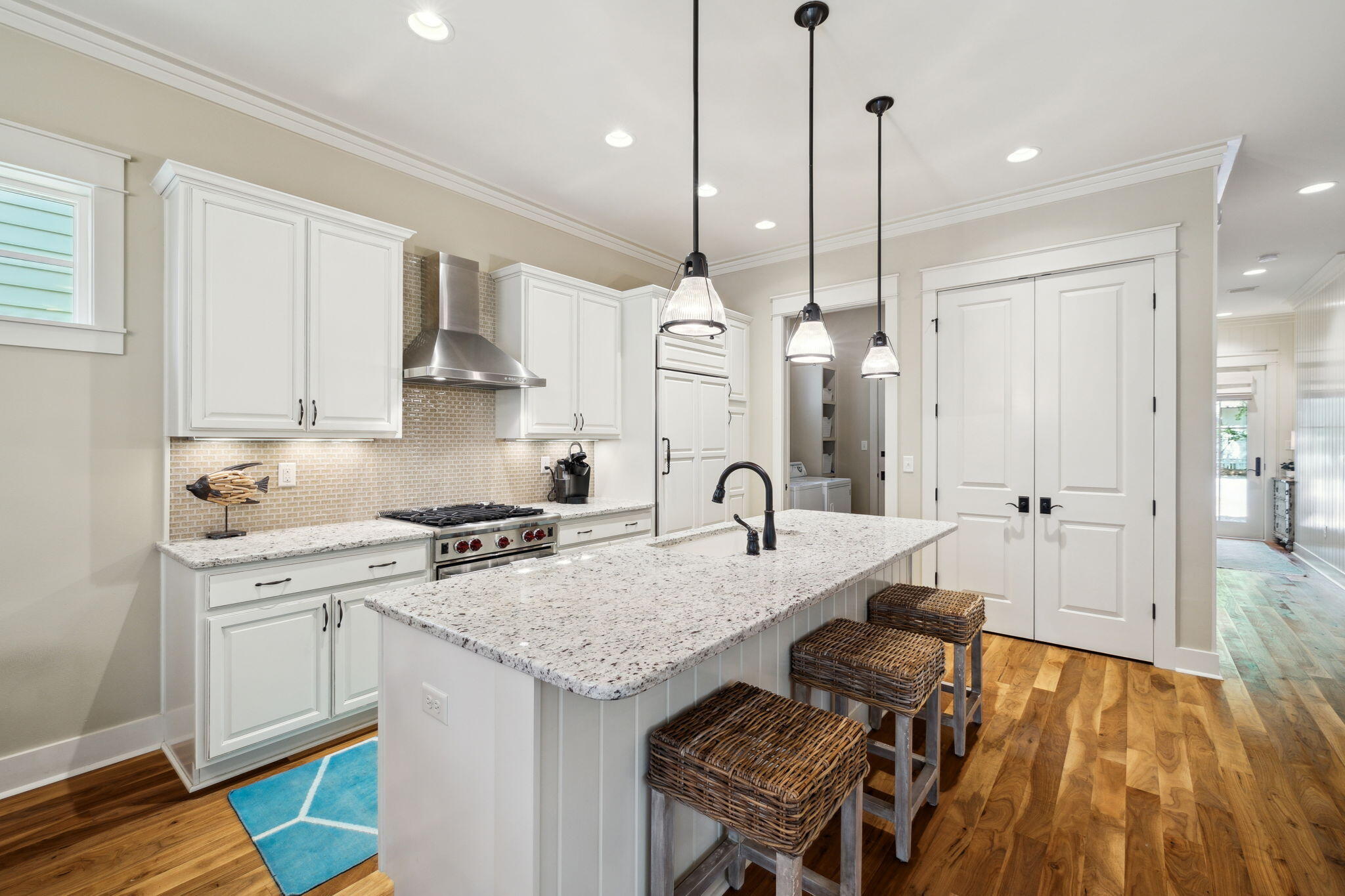 45 Plimsoll Way Santa Rosa Beach, FL 32459 - Photo 7 of 42 a kitchen with stainless steel appliances granite countertop a sink a stove and a wooden floor