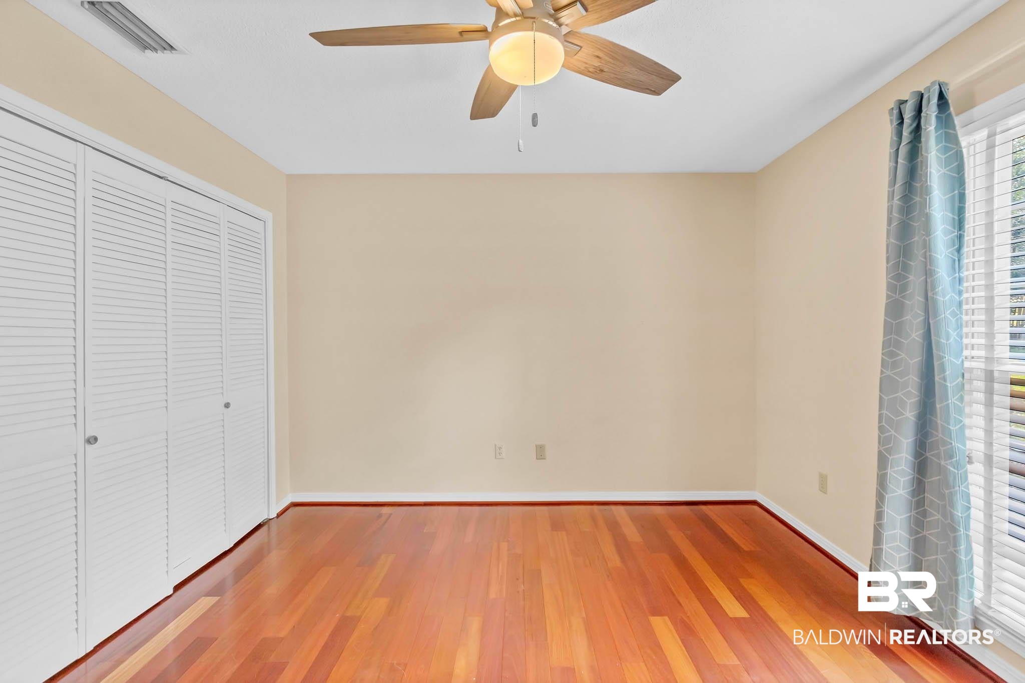 309 West Brandy Run Road Mobile, AL 36608 - Photo 54 of 100 Unfurnished bedroom featuring wood finished floors, a closet, and a ceiling fan