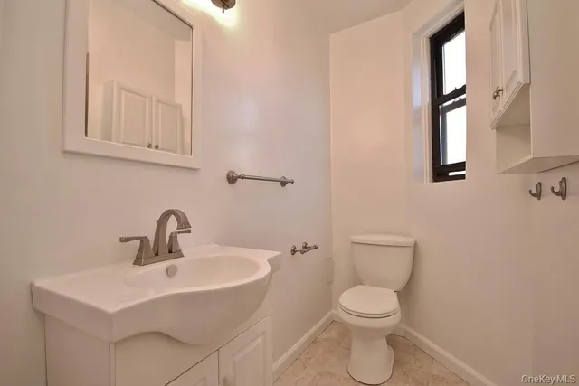 a white toilet sitting next to a bathroom sink