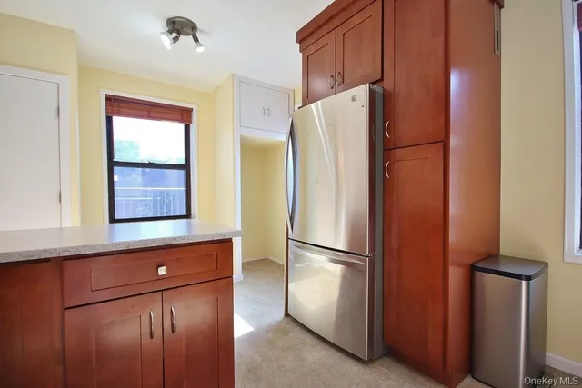 a metallic refrigerator freezer sitting in a kitchen