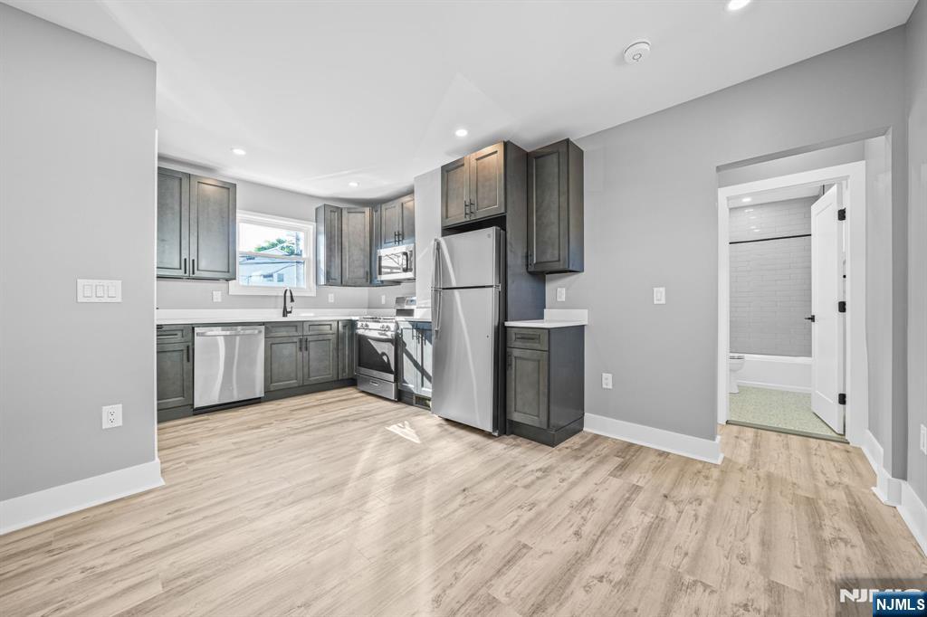 100 Kansas Street, Unit 1 Hackensack, NJ 07601 - Photo 4 of 17 a kitchen with stainless steel appliances a refrigerator and a sink