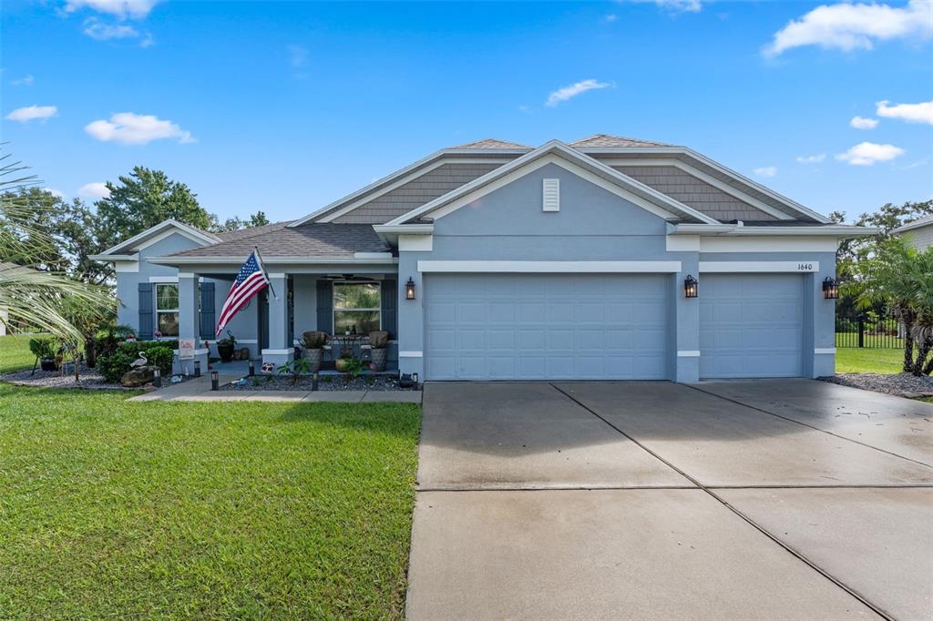 a front view of house with yard outdoor seating and garage