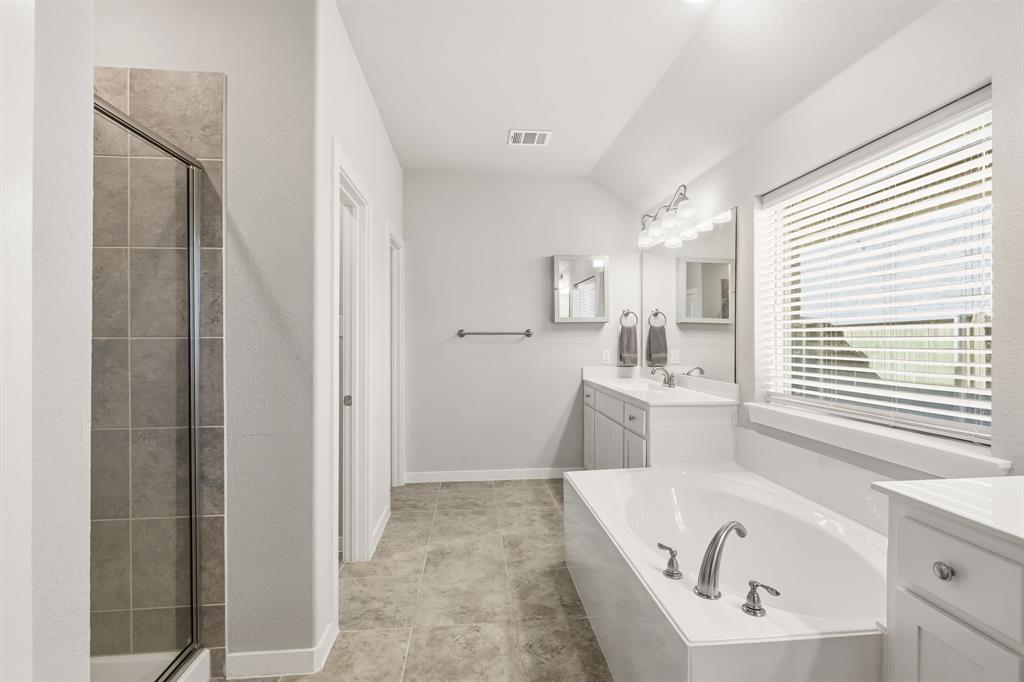 3921 Madison Lane Denton, TX 76208 - Photo 11 of 37 a bathroom with a tub sink and mirror