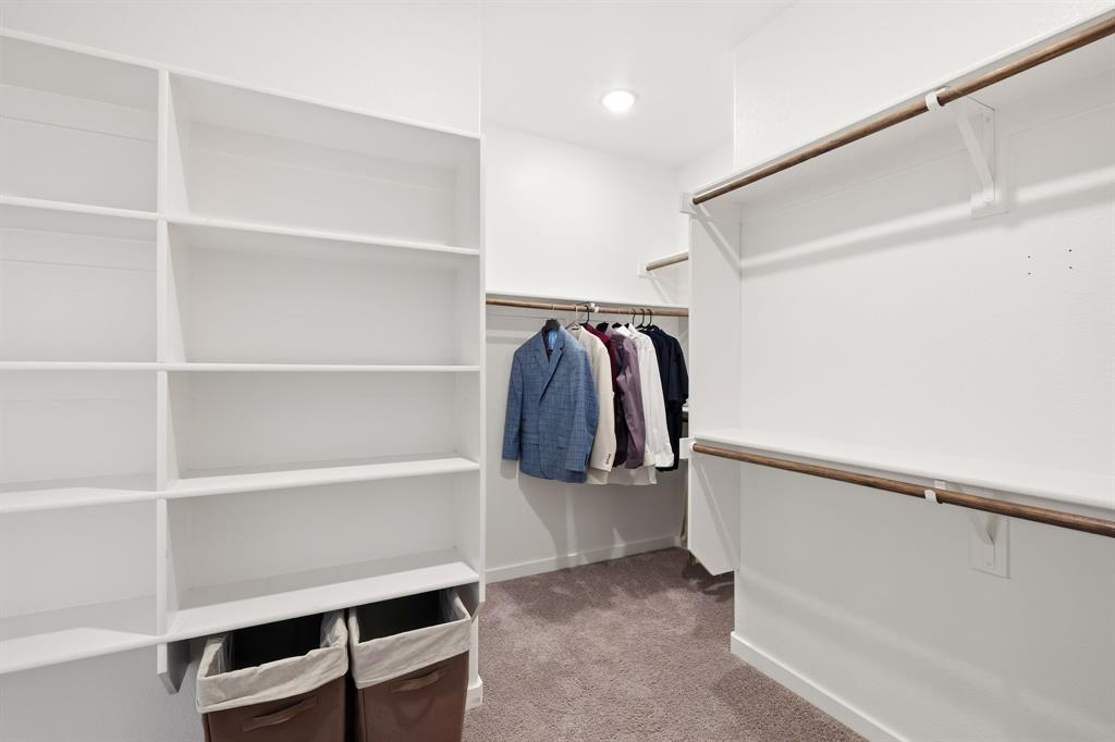 3921 Madison Lane Denton, TX 76208 - Photo 12 of 37 a view of walk in closet with clothes and shoes