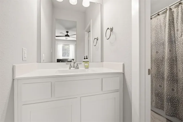 a bathroom with a sink vanity and a mirror