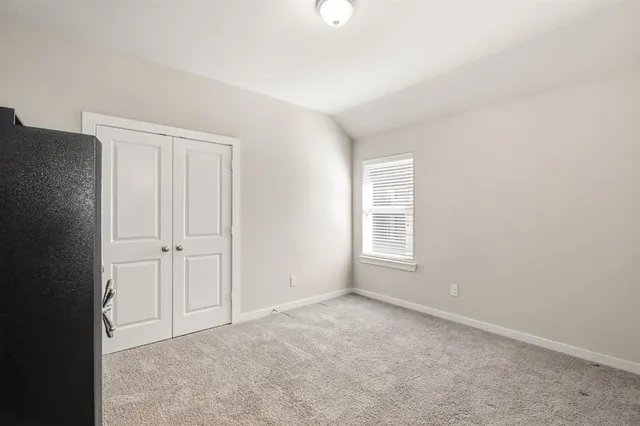an empty room with windows and closet