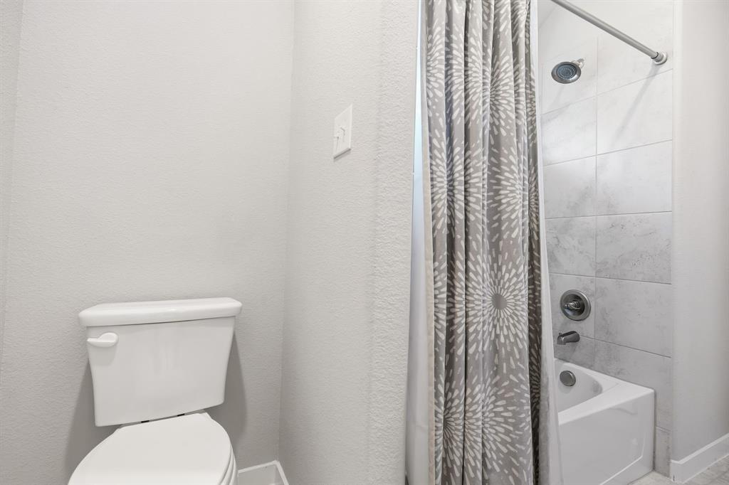 3921 Madison Lane Denton, TX 76208 - Photo 19 of 37 a white toilet sitting next to a shower