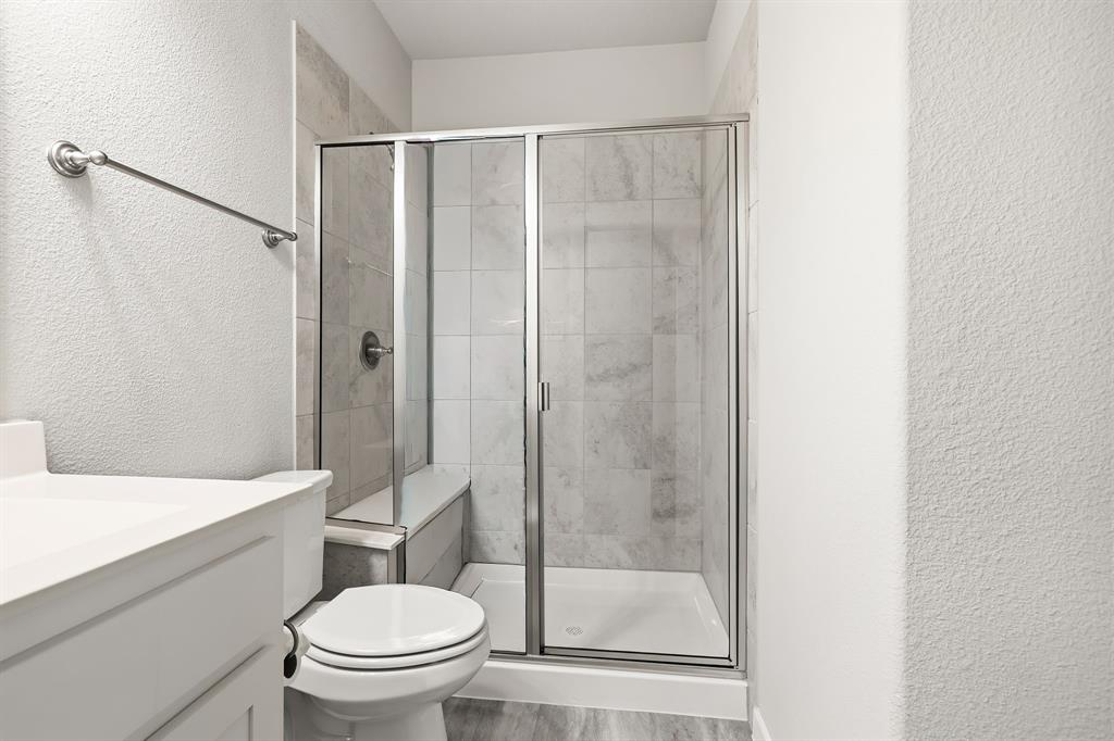 3921 Madison Lane Denton, TX 76208 - Photo 23 of 37 a bathroom with a shower a toilet and a sink