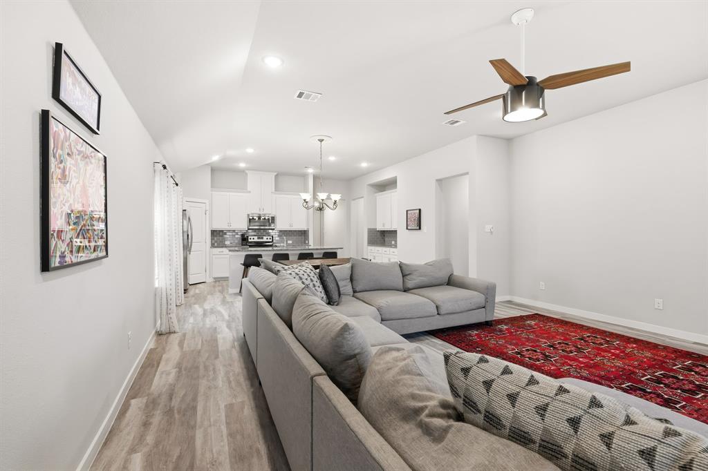 3921 Madison Lane Denton, TX 76208 - Photo 27 of 37 a living room with furniture and a rug